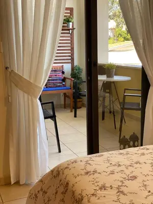 a bedroom with a bed and a window and a table at Kition Cozy Residence in Larnaka
