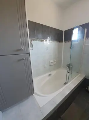 a bathroom with a shower and a bath tub at Bright and Cozy 2-Bedroom Apartment in Strovolos in Strovolos