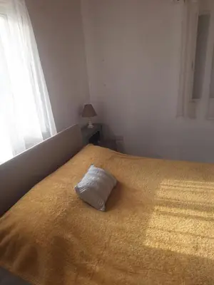 a pillow sitting on top of a bed at Big house near sea, shared swimming pool in Voroklini
