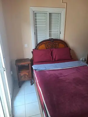 a bedroom with a bed and a table and a window at Big house near sea, shared swimming pool in Voroklini