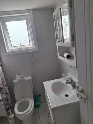 a bathroom with a toilet and a sink and a window at Big house near sea, shared swimming pool in Voroklini