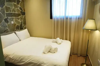 a bedroom with a bed with towels on it at Luxury 5-Bedroom Chalet Kalopanayiotis in Kalopanayiotis