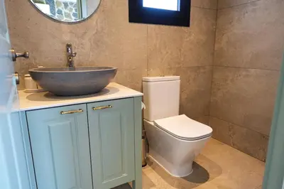 a bathroom with a sink and a toilet at Luxury 5-Bedroom Chalet Kalopanayiotis in Kalopanayiotis