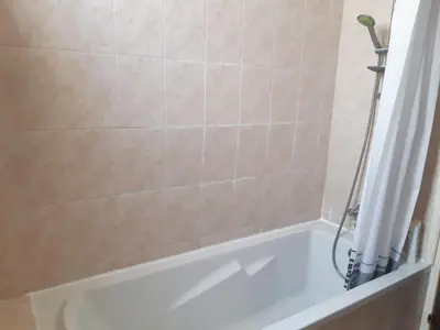 a bathroom with a bath tub with a shower at Cozy apartment in Larnaka