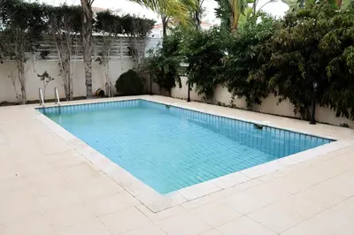 a swimming pool with blue water in a yard at Anthorina Villa 21 in Protaras