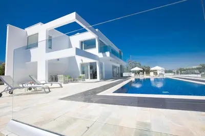 a large white house with a swimming pool at Villa Marilia in Protaras