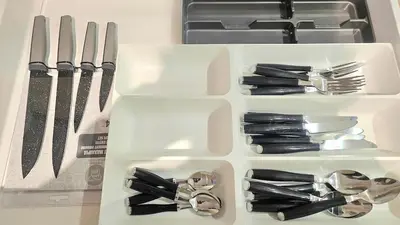 a white drawer filled with utensils on a counter at Touch of class Molos Limassol in Limassol