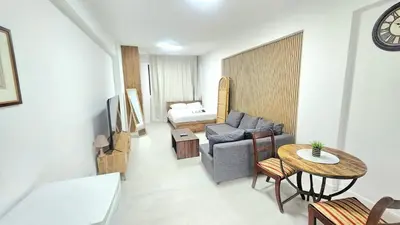 a living room with a couch and a table at Antionette Studio Apartment in Limassol