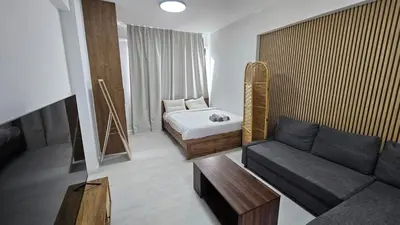 a living room with a couch and a bed at Antionette Studio Apartment in Limassol