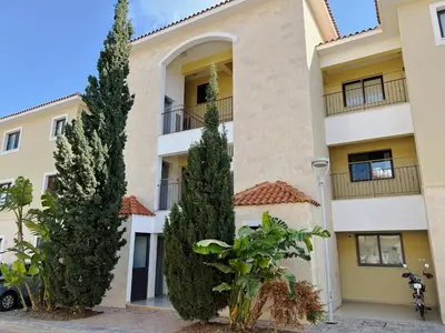 a building with two trees in front of it at THE A-LINE SEAVIEW MALAMA APARTMENT with pool, tennis court & gym in Paralimni