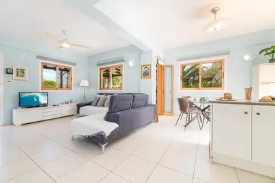 a living room with a couch and a table at Tranquility Villa in Ayia Napa