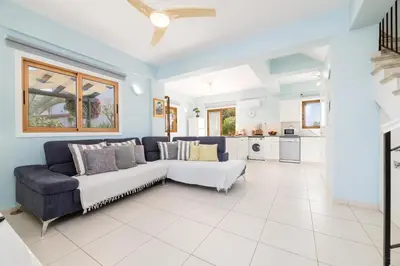 a living room with a couch and a table at Tranquility Villa in Ayia Napa