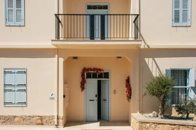 a house with a balcony and a door at Siogkas Inn in Dherinia