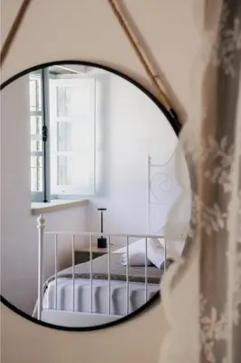 a mirror reflection of a bed in a bedroom at Siogkas Inn in Dherinia