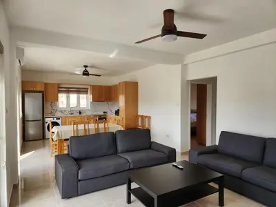 a living room with two couches and a table at Kafkalia Sea Breeze in Larnaka