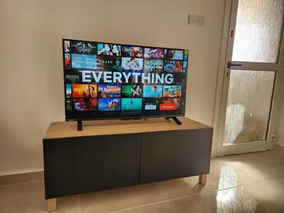 a flat screen tv sitting on top of a cabinet at Kafkalia Sea Breeze in Larnaka