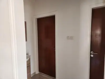 a door in a room with a brown door at Kafkalia Sea Breeze in Larnaka