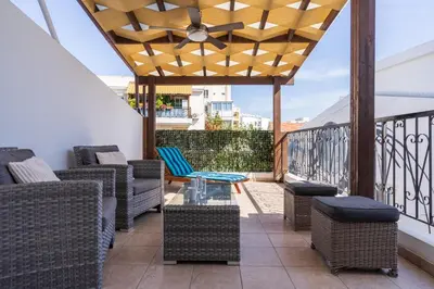 a patio with chairs and tables on a balcony at Carisa flat, 2 bedrooms in Larnaka