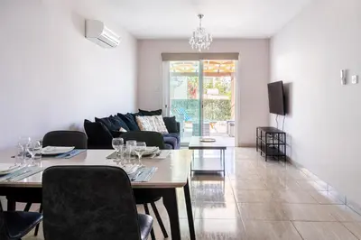 a living room with a table and a couch at Carisa flat, 2 bedrooms in Larnaka