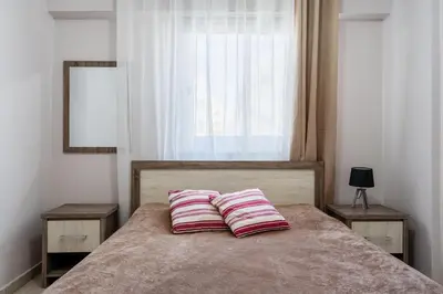 a bedroom with a bed with two pillows on it at Carisa flat, 2 bedrooms in Larnaka