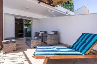 a patio with a chair and a table at Carisa flat, 2 bedrooms in Larnaka