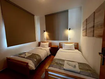 two beds in a small room with at Villa Solmare in Pervolia