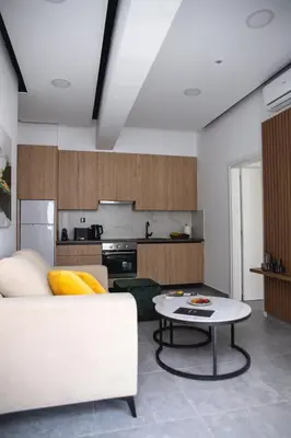a living room with a white couch and a table at Le Bouquet Luxury Suites Ltd in Nicosia
