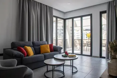 a living room with a couch and a table at Le Bouquet Luxury Suites Ltd in Nicosia