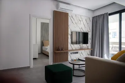 a living room with a couch and a tv at Le Bouquet Luxury Suites Ltd in Nicosia
