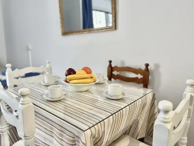 a dining room table with a bowl of fruit on it at STAY NISSI Chrysland Studios in Ayia Napa
