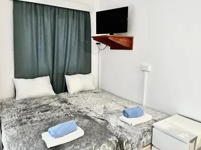 a bedroom with a bed with blue towels on it at STAY NISSI Chrysland Studios in Ayia Napa
