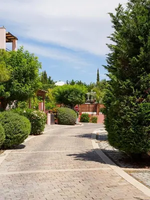a brick road with trees and a stop sign at Mediterranean Escape - Coastal 2-Bedroom Apartment Limassol in Limassol