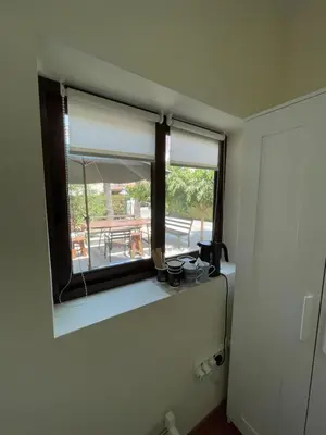a bathroom with a window with a view of a patio at Yard room with private entrance in Larnaka