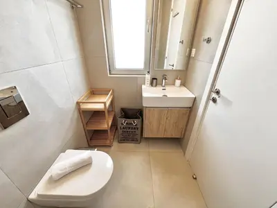 a small bathroom with a toilet and a sink at STAY Mythical Blue Apartment in Protaras