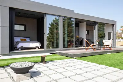 a bedroom in a glass house with a garden at Mi Filoxenia 2 in Aglantzia