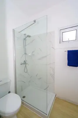 a bathroom with a shower and a toilet at Kitieos 163 Suite in Finikoudes in Larnaka