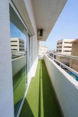 a balcony with green flooring on a building at Kitieos 163 Suite in Finikoudes in Larnaka