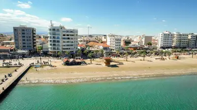 a view of a beach with hotels and buildings at Kitieos 163 Suite in Finikoudes in Larnaka