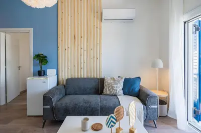 a living room with a couch and a table at Seacret - 1-BR Apartment & Pool in Pyla in Pyla
