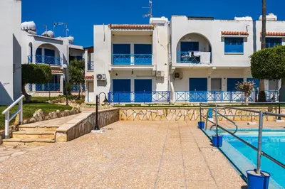 a house with a swimming pool in front of it at Seacret - 1-BR Apartment & Pool in Pyla in Pyla