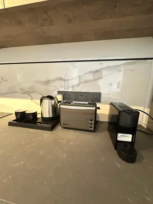a kitchen with a microwave and some pots and pans at 204 Lux Suites Level2 Tower 206 in Nicosia