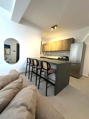 a kitchen with a table and chairs in a room at 204 Lux Suites Level2 Tower 206 in Nicosia