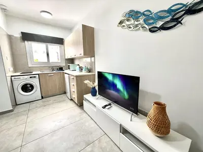 a living room with a tv and a kitchen at STAY Napa Ocean Apartment in Ayia Napa