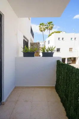 a white wall with potted plants on top of it at Cozy Apartment in Kapparis # 506 in Paralimni