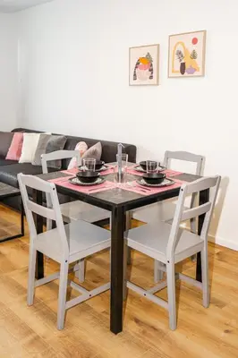 a dining room table with two white chairs and a table at Cozy Apartment in Kapparis # 506 in Paralimni