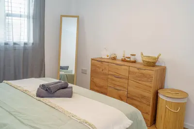 a bedroom with a bed and a dresser with a mirror at Cozy Apartment in Kapparis #80 in Paralimni