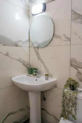 a bathroom with a sink and a mirror at Cozy Apartment in Kapparis #80 in Paralimni