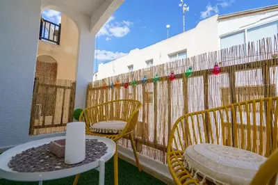 a balcony with chairs and a table and a fence at Cozy Apartment in Kapparis #80 in Paralimni