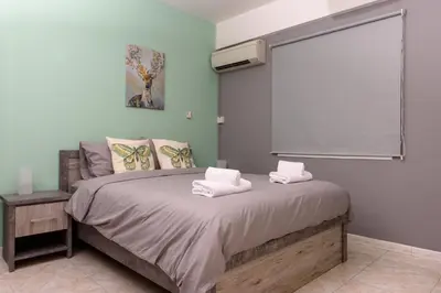 a bedroom with a bed with towels on it at Azura 3 Bedroom Apartment in Larnaka