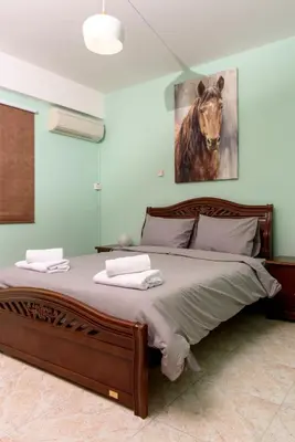 a bedroom with a large bed with a painting of a horse at Azura 3 Bedroom Apartment in Larnaka
